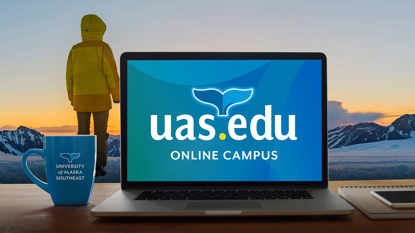 Computer with a person standing in a winter landscape background